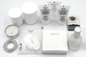 pexels-photo-31865248-31865248 Flat lay of luxury hotel toiletries and amenities, including body lotion, shampoo, and scented candles.
